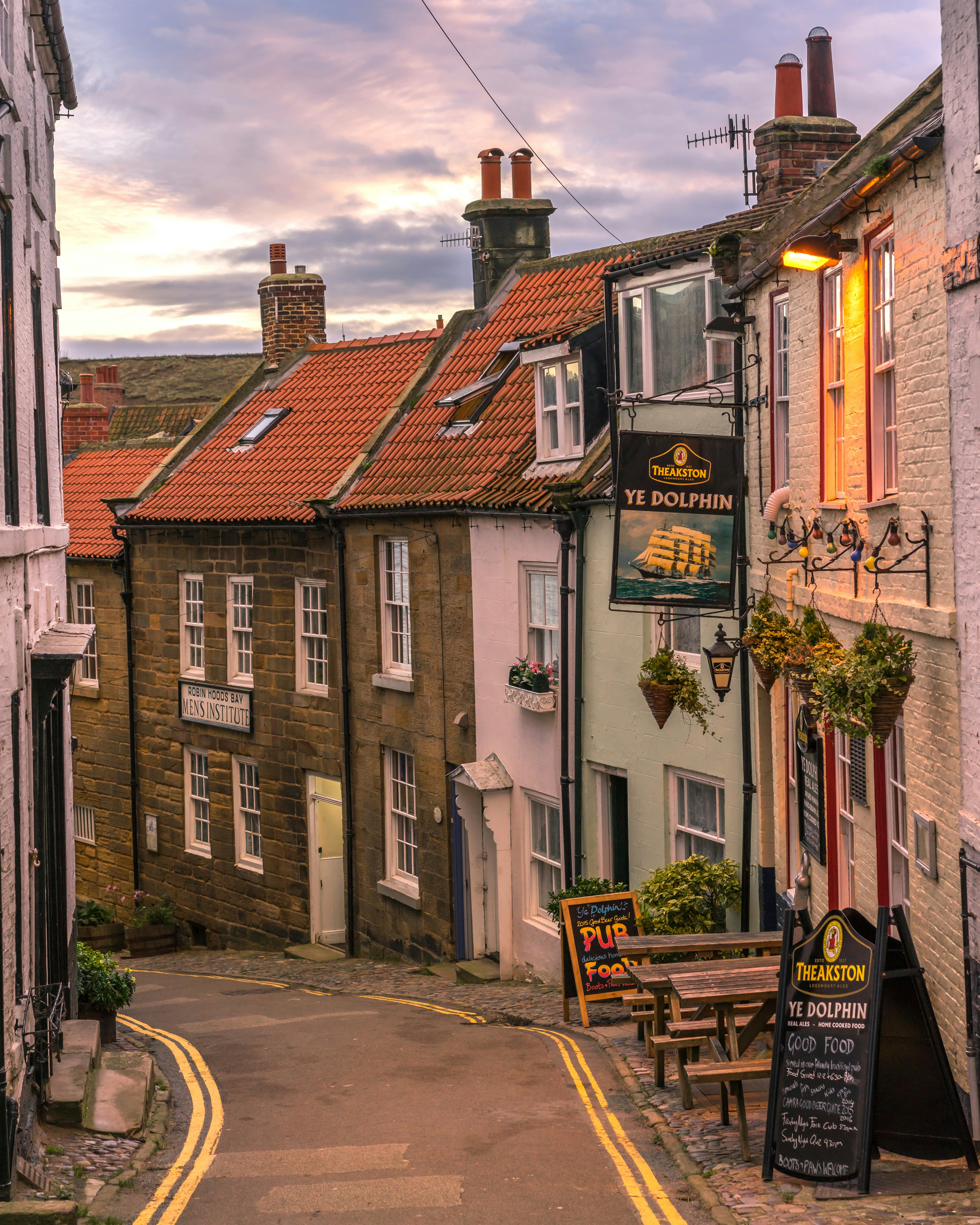 Traditional pub on a narrow street in Robin Hood’s Bay, North Yorkshire at dusk